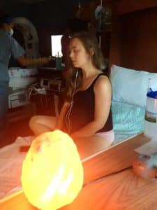 pregnant woman in labor, sitting up on bed listening to hypnosis tracks
