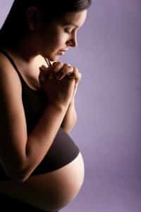 Christianity and Hypnobabies.Pregnant Person Praying using Christianity and Hypnobabies