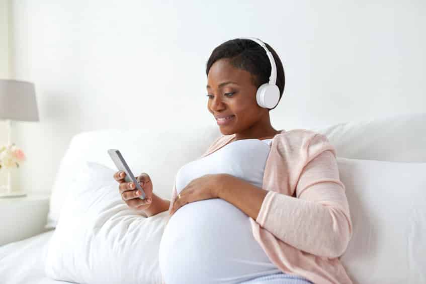 "Woman with headphones listening to How Does Hypnobirthing Work"