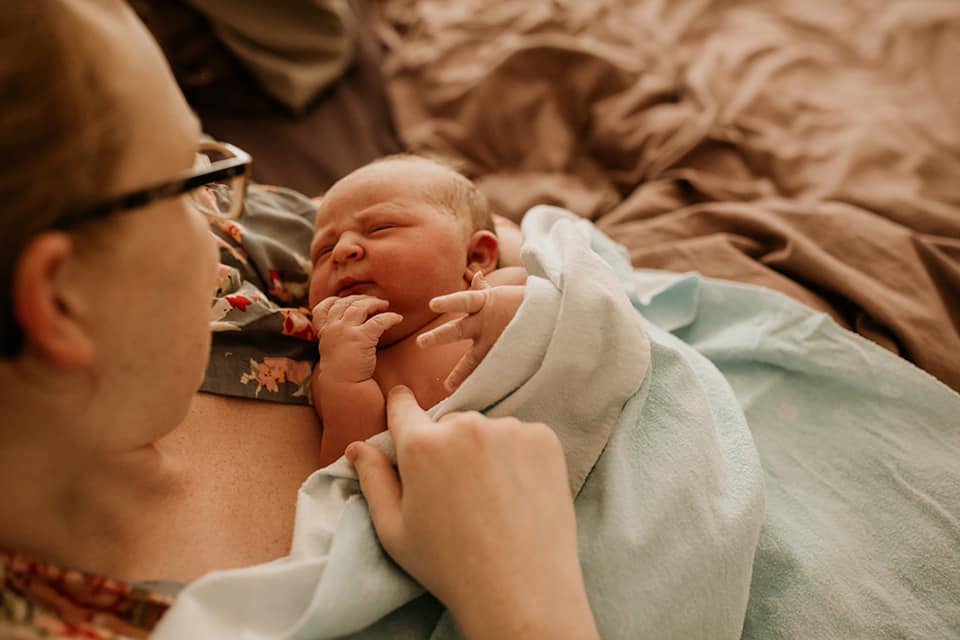 Hypno-mom Amanda gazing down at her newborn baby