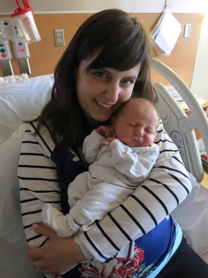 Hypno-mom Rachel holding her newborn baby and smiling