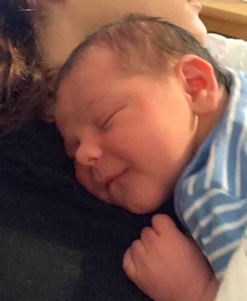 Hypno-mom Emily's newborn baby boy smiling.