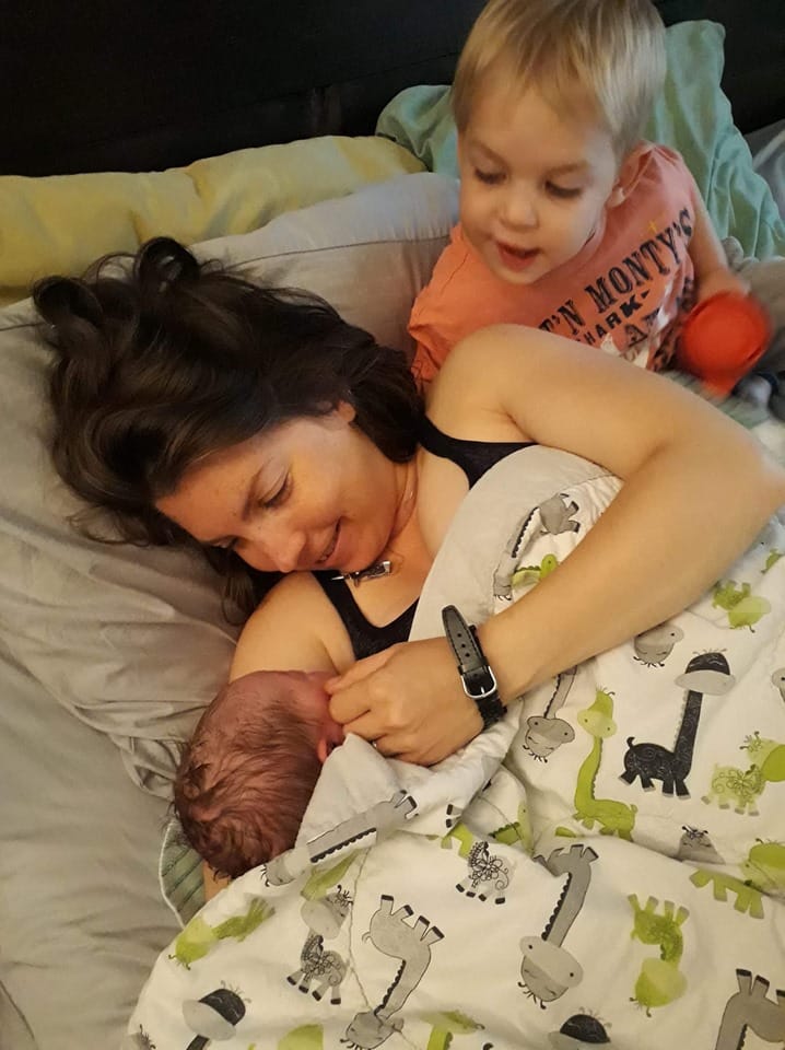 Hypno-mom Steph laying in bed with newborn baby and son.