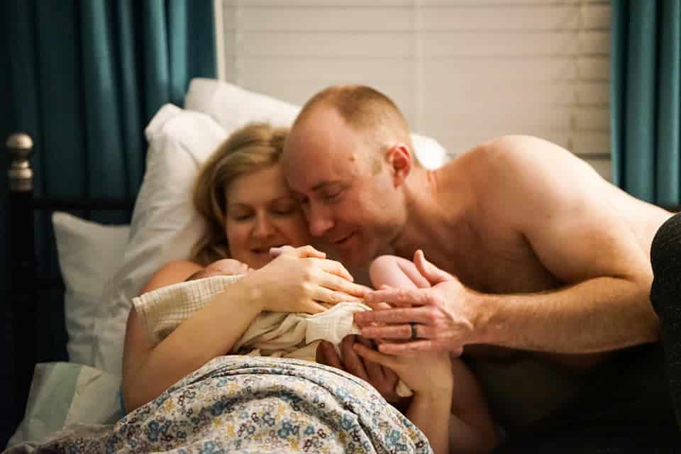Hypno-couple adoring their newborn baby