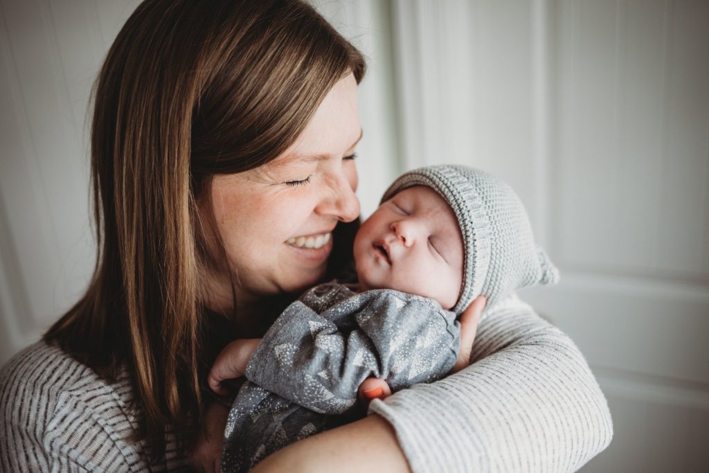 Hypno-mom Tiffany laughing and holding newborn