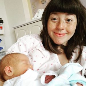 Hypno-mom Smiling and holding newborn