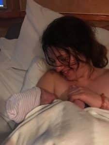 Hypno-mom cuddling with newborn in hospital bed