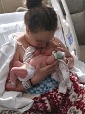 Hypno mom in hospital bed kissing newborn