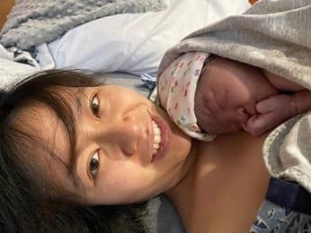 Hypno mom skin to skin with newborn and smiling