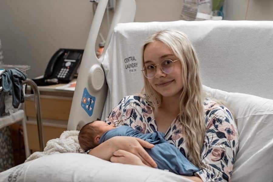 Hypno-mom sitting up in hospital bed holding newborn baby