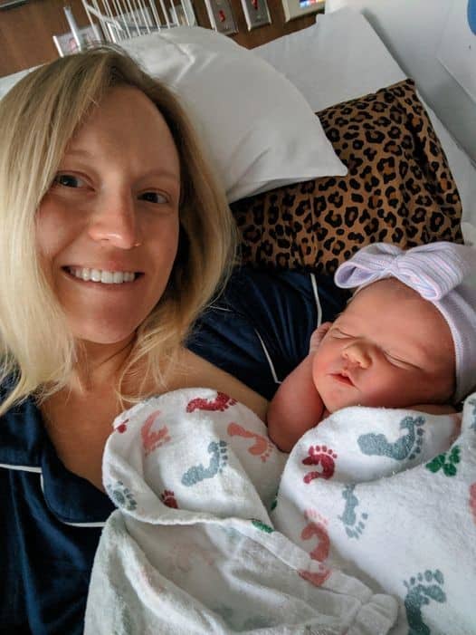 Hypno-mom smiling while holding newborn