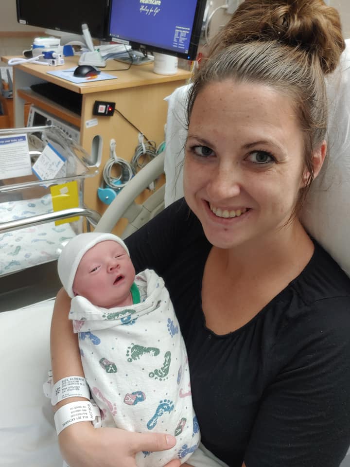 Hypno-mom smiling and holding newborn baby
