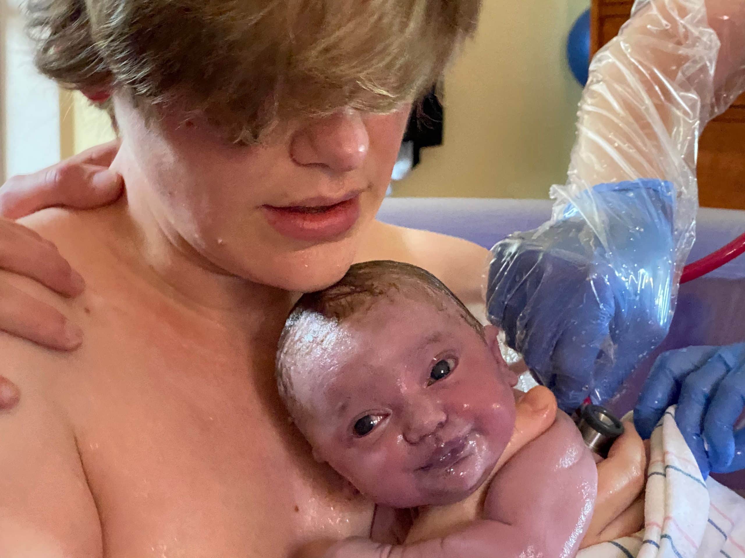 hypno student holding brand new baby just after waterbirth
