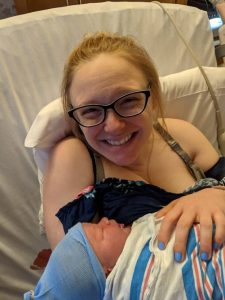 new parent in hospital holding newborn baby