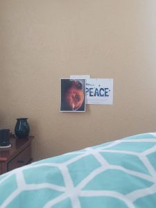 Peace sign hanging on wall with photo of pregnant belly with orange hypnoanesthesia