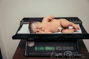 newborn baby on a scale