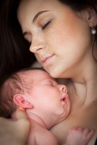 Hypno-student cuddling newborn baby