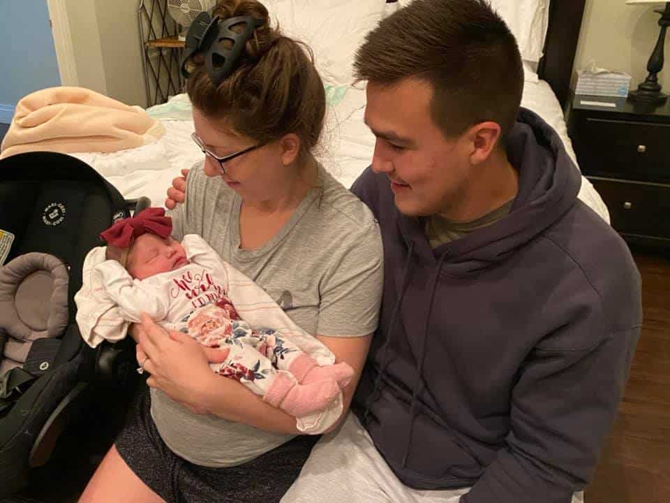 new parents holding newborn baby