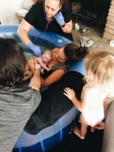 Birthing family with new baby just after waterbirth