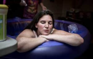 Birthing person relaxing in birth tub