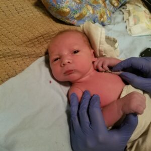 Newborn baby being examined
