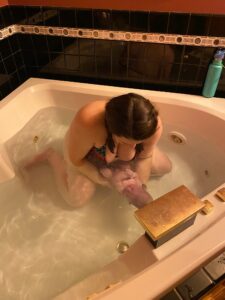 Baby being born in tub