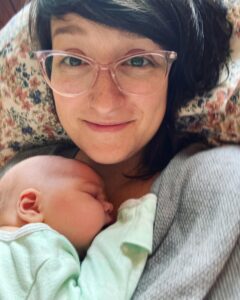 New parent cuddling with newborn baby