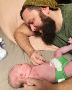 New parent looking at newborn baby