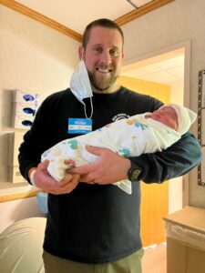 New dad holding newborn baby