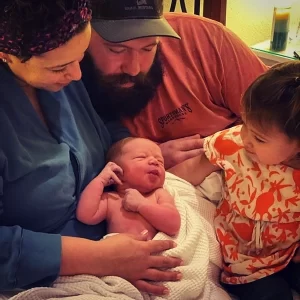 New family looking at newborn baby