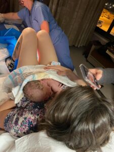 New parent holding newborn immediately after birth