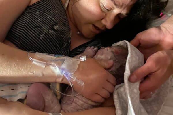 Hypnobabies student holding and drying off newborn baby
