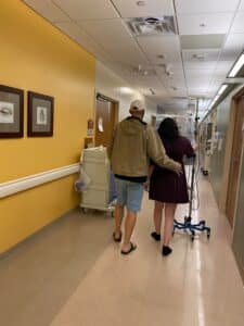 Hypnobabies couple walking halls of hospital with iv pole