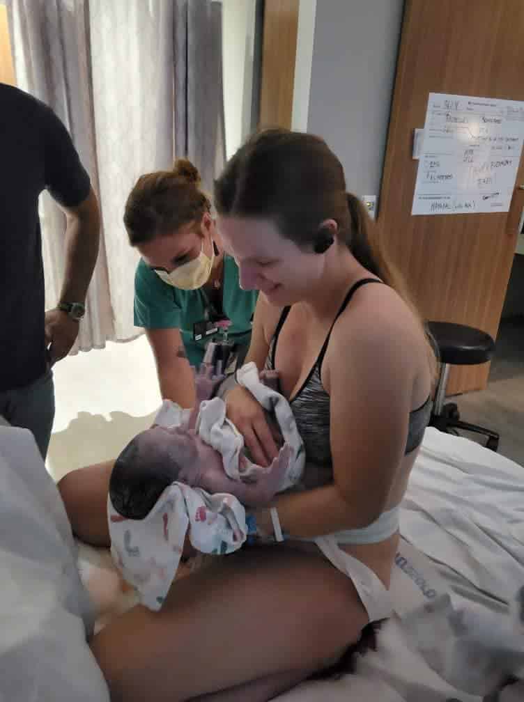 Hypno-student holding newborn just after birth