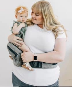 Blonde mom and baby using TushBaby Hip Carrier