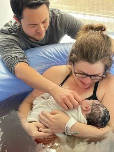 New Family holding Newborn in tub after Hypnobabies Grounded and Calm VBAC