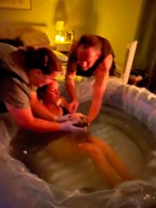 Hypnobabies couple welcoming new baby in birth tub